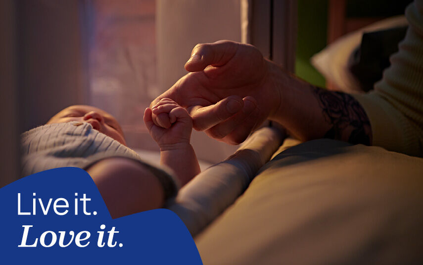 A baby holding a parent's finger. Chicco: Live it. Love it.